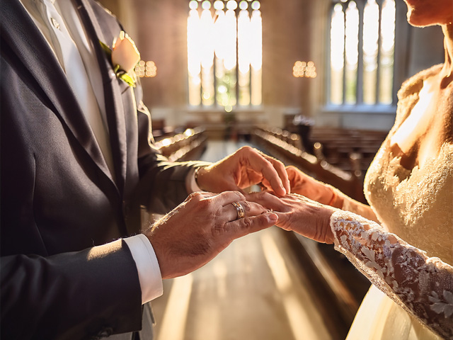 A couple exchanging rings at their wedding